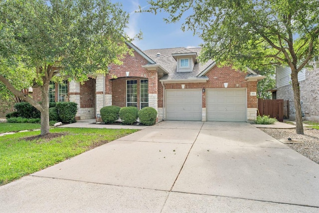 112 Mcbride Ln, Cedar Park, TX 78613 - traditional home with an attached garage, brick siding, concrete driveway, and a shingled roof