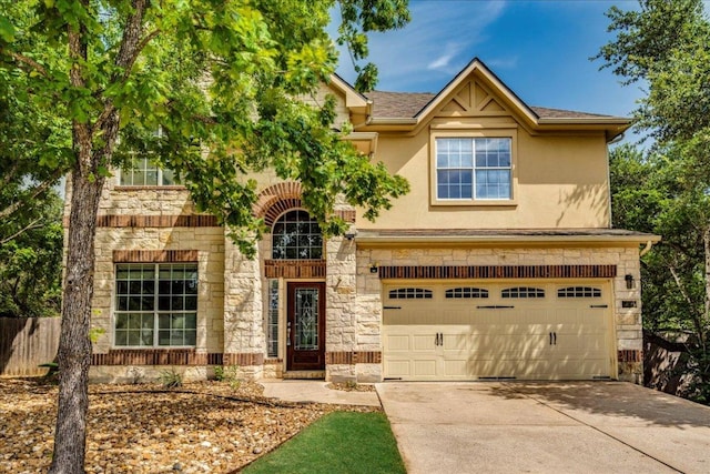8024 Levata Dr, Austin, TX 78739 - view of front of home with stone siding, a garage, concrete driveway, and stucco siding