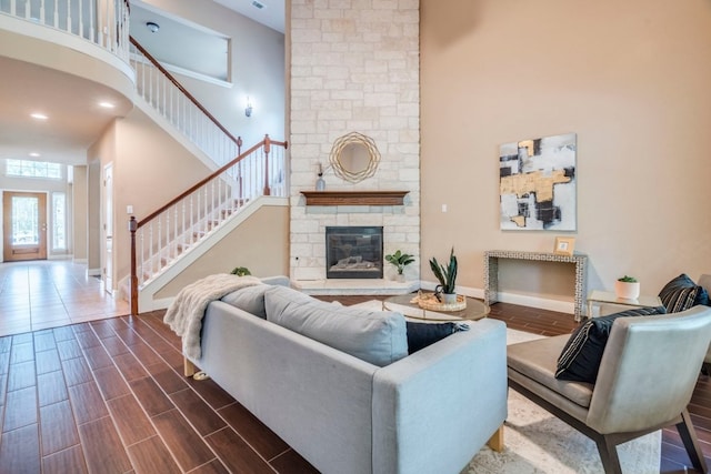 8024 Levata Dr, Austin, TX 78739 - living area with a towering ceiling, stairs, a fireplace, and dark wood-style floors