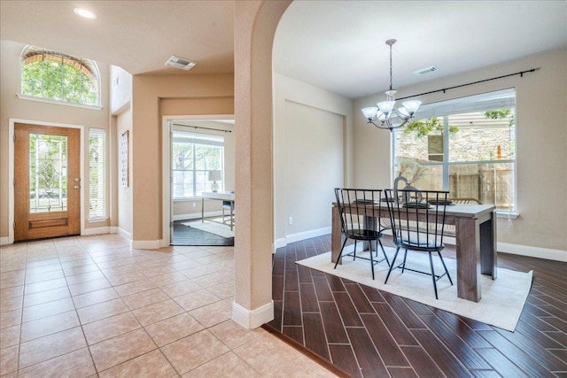 8024 Levata Dr, Austin, TX 78739 - dining room featuring healthy amount of natural light, a chandelier, wood finished floors, arched walkways, and recessed lighting