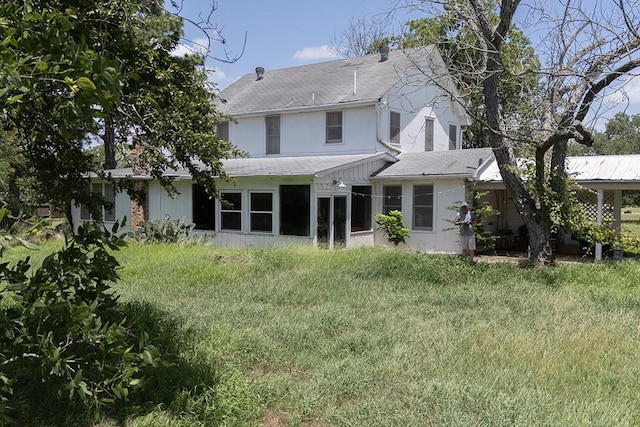 3508 Moulton Rd, Gonzales, TX 78629 - rear view of property featuring roof with shingles and a sunroom