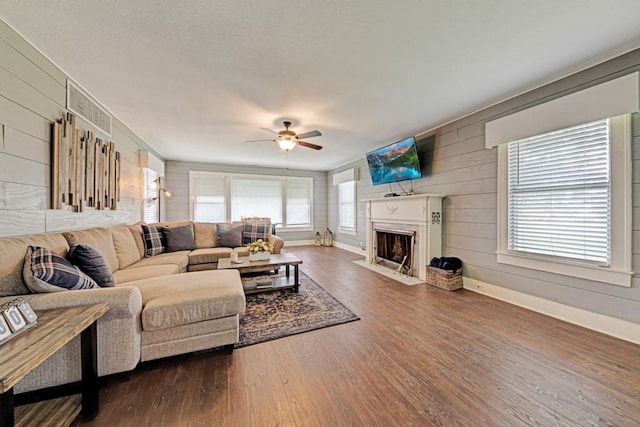 3508 Moulton Rd, Gonzales, TX 78629 - living room featuring wooden walls, healthy amount of natural light, a ceiling fan, and dark wood-type flooring