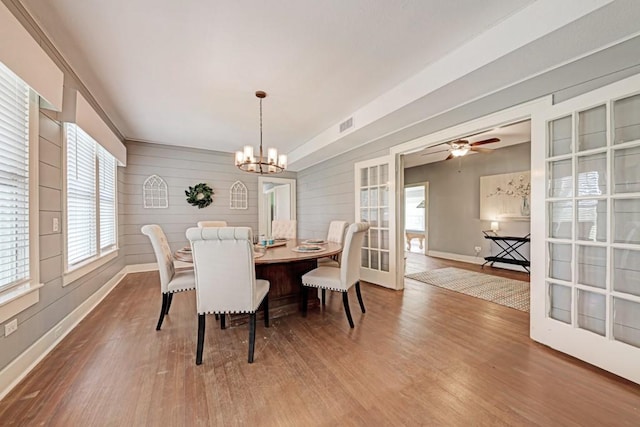 3508 Moulton Rd, Gonzales, TX 78629 - dining space with wood finished floors, a chandelier, plenty of natural light, and wooden walls