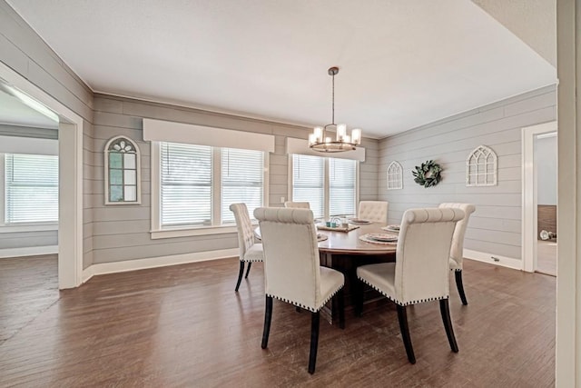 3508 Moulton Rd, Gonzales, TX 78629 - dining room featuring dark wood-style flooring, a chandelier, and wood walls