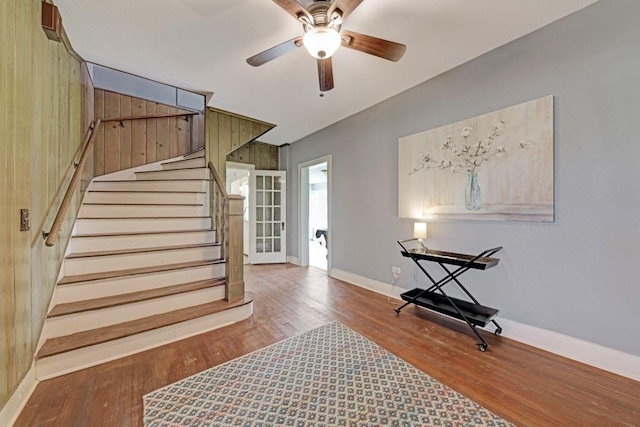 3508 Moulton Rd, Gonzales, TX 78629 - stairs featuring wood finished floors, a ceiling fan, and wooden walls