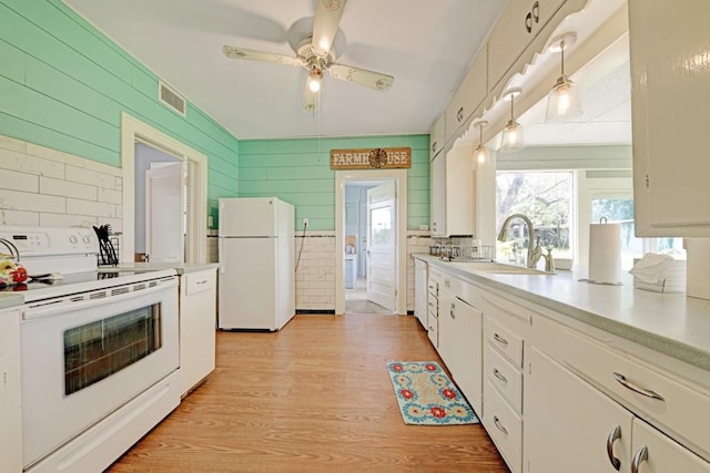 3508 Moulton Rd, Gonzales, TX 78629 - kitchen with white appliances, light countertops, light wood-style flooring, white cabinetry, and a ceiling fan
