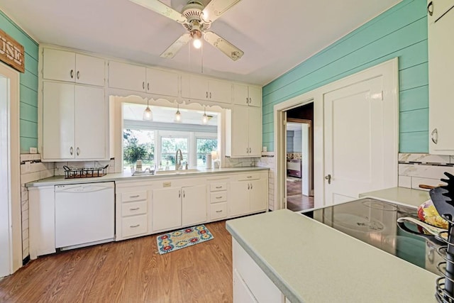 3508 Moulton Rd, Gonzales, TX 78629 - kitchen featuring dishwasher, ceiling fan, light wood-type flooring, white cabinets, and wooden walls