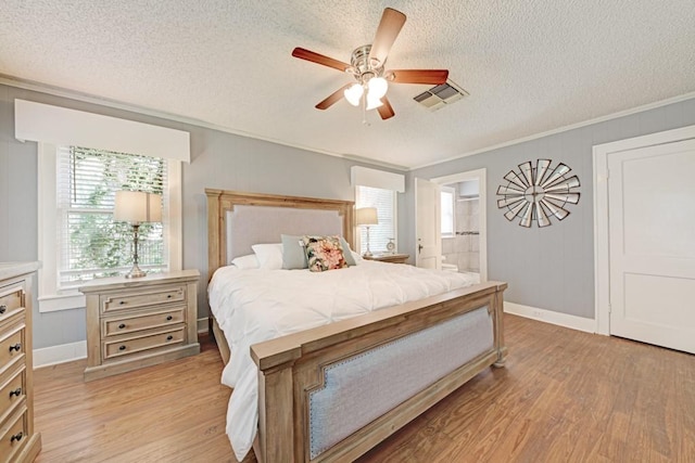 3508 Moulton Rd, Gonzales, TX 78629 - bedroom with a textured ceiling, light wood-style floors, crown molding, ceiling fan, and ensuite bath