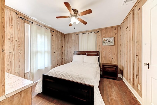 3508 Moulton Rd, Gonzales, TX 78629 - bedroom featuring wood finished floors, wood walls, and a ceiling fan