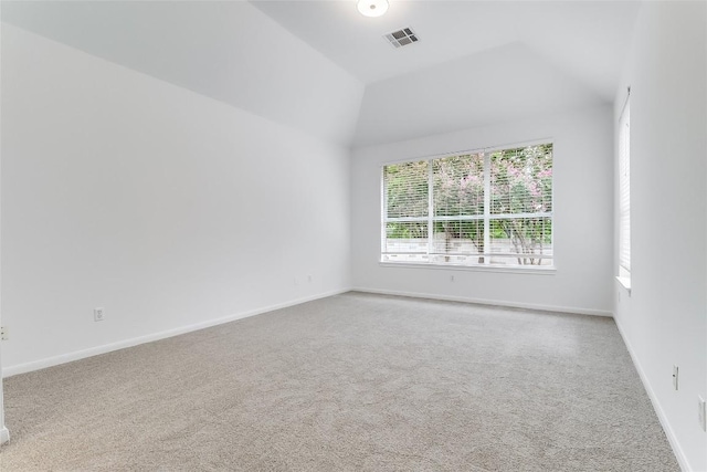 12608 Chittim Cir, Austin, TX 78732 - spare room featuring plenty of natural light, carpet flooring, and vaulted ceiling