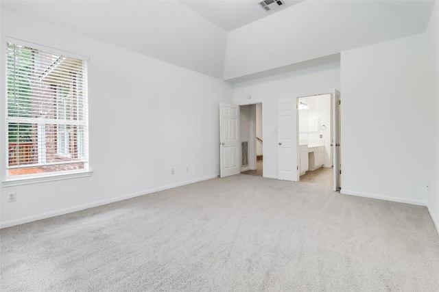 12608 Chittim Cir, Austin, TX 78732 - unfurnished bedroom with light carpet, multiple windows, a high ceiling, and ensuite bathroom