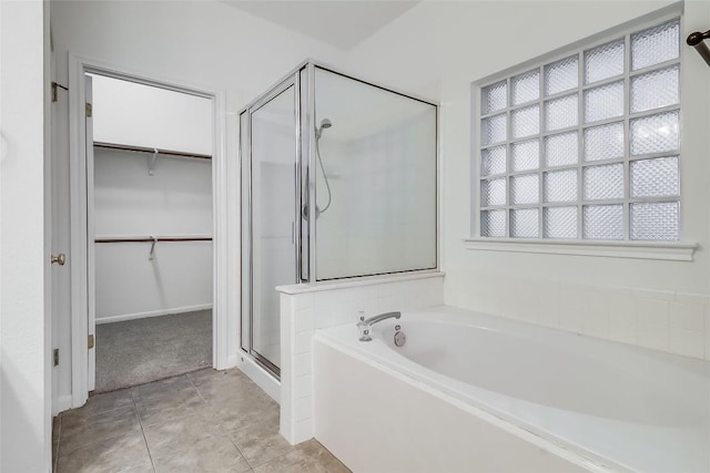 12608 Chittim Cir, Austin, TX 78732 - bathroom featuring a shower stall, a bath, a spacious closet, and tile patterned floors