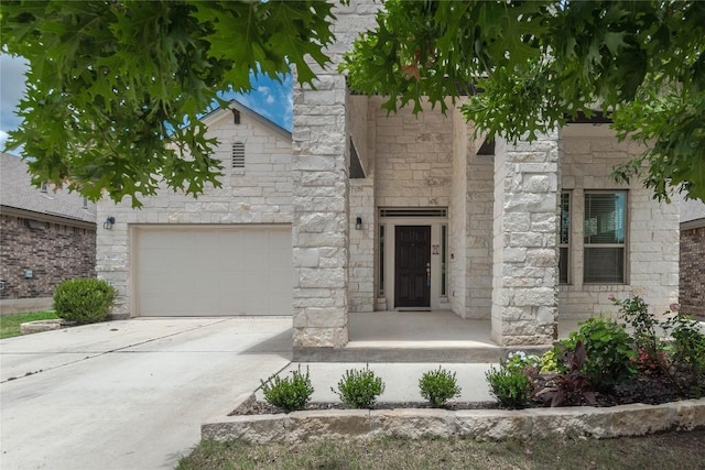 632 Schefer St, Leander, TX 78641 - view of front facade with stone siding, a garage, and driveway