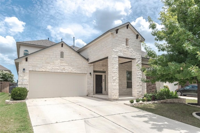 632 Schefer St, Leander, TX 78641 - view of front of house with stone siding, driveway, a garage, and a porch