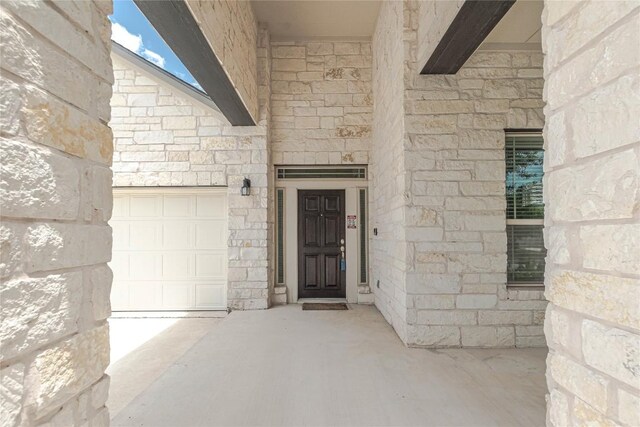 632 Schefer St, Leander, TX 78641 - view of exterior entry with stone siding and a garage