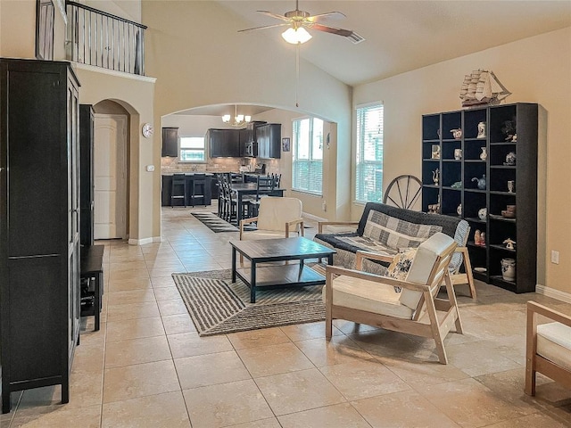632 Schefer St, Leander, TX 78641 - living room with arched walkways, a ceiling fan, high vaulted ceiling, and light tile patterned flooring
