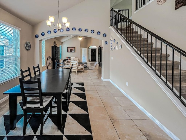 632 Schefer St, Leander, TX 78641 - dining room with arched walkways, light tile patterned floors, a chandelier, stairway, and vaulted ceiling