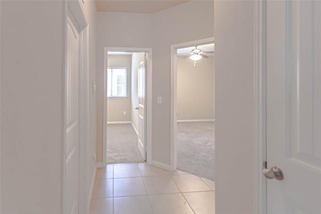 632 Schefer St, Leander, TX 78641 - hallway featuring light carpet and light tile patterned flooring