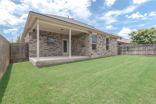 632 Schefer St, Leander, TX 78641 - back of property with brick siding, a patio area, and a fenced backyard
