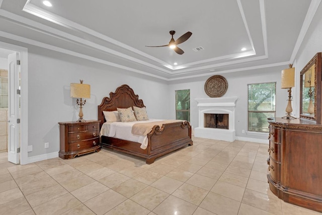 1130 Whispering Water, Spring Branch, TX 78070 - bedroom with a tray ceiling, a fireplace with raised hearth, light tile patterned flooring, recessed lighting, and a ceiling fan