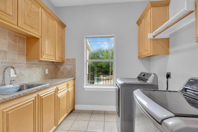 1130 Whispering Water, Spring Branch, TX 78070 - washroom featuring washer and dryer, cabinet space, and light tile patterned floors