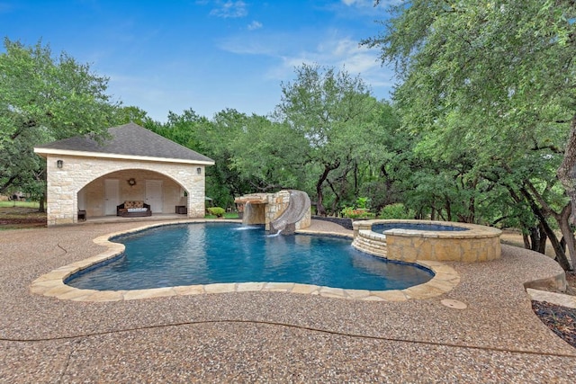 1130 Whispering Water, Spring Branch, TX 78070 - view of pool with a patio area, a pool with connected hot tub, an outdoor stone fireplace, and view of scattered trees
