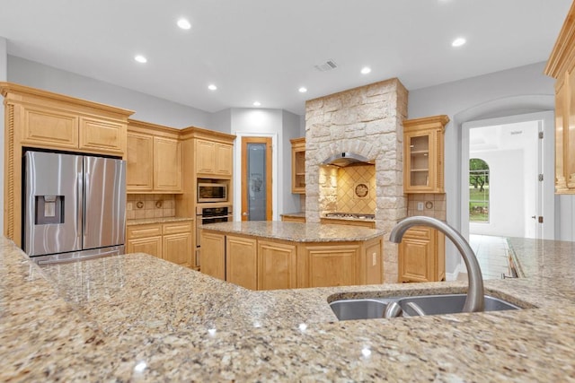 1130 Whispering Water, Spring Branch, TX 78070 - kitchen with appliances with stainless steel finishes, light stone counters, tasteful backsplash, recessed lighting, and light brown cabinets