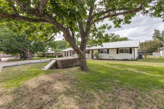 606 Lilac Dr, Round Rock, TX 78664 - view of front of house featuring a metal roof and stone siding