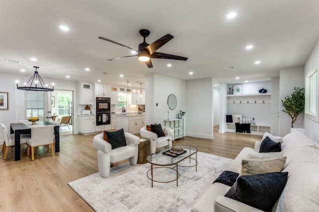 606 Lilac Dr, Round Rock, TX 78664 - living area featuring a chandelier, light wood finished floors, recessed lighting, and a ceiling fan