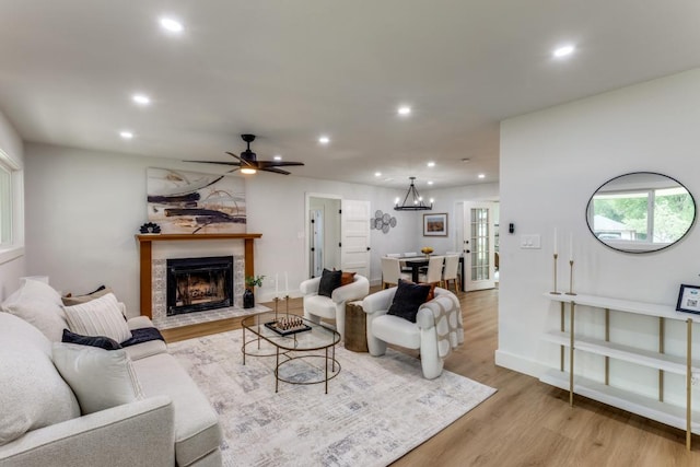 606 Lilac Dr, Round Rock, TX 78664 - living area featuring light wood-style flooring, recessed lighting, a fireplace with flush hearth, and a ceiling fan