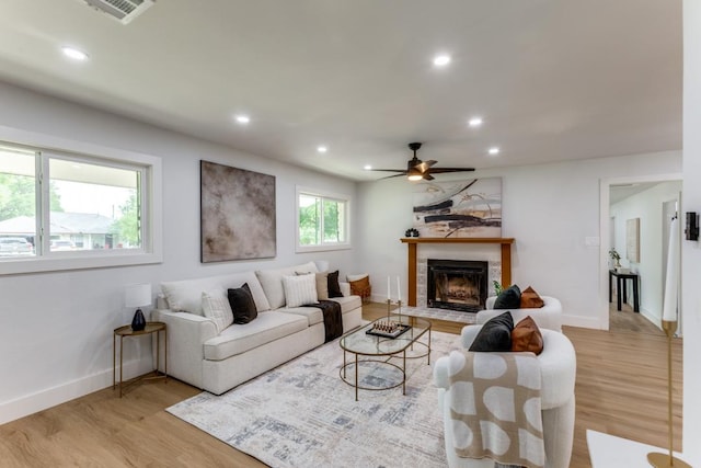 606 Lilac Dr, Round Rock, TX 78664 - living area with light wood-style flooring, recessed lighting, a fireplace with flush hearth, and ceiling fan