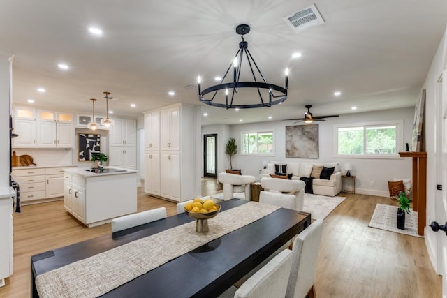 606 Lilac Dr, Round Rock, TX 78664 - dining area featuring recessed lighting, light wood-style flooring, ceiling fan, and a chandelier