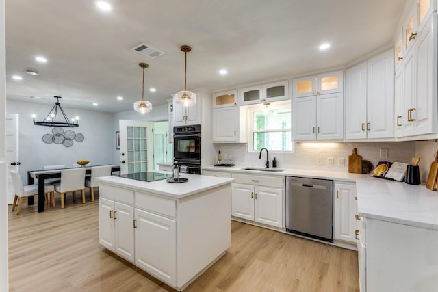 606 Lilac Dr, Round Rock, TX 78664 - kitchen with black appliances, decorative backsplash, light wood-style floors, white cabinets, and recessed lighting