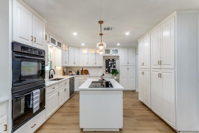 606 Lilac Dr, Round Rock, TX 78664 - kitchen featuring black appliances, a kitchen island, white cabinetry, and recessed lighting