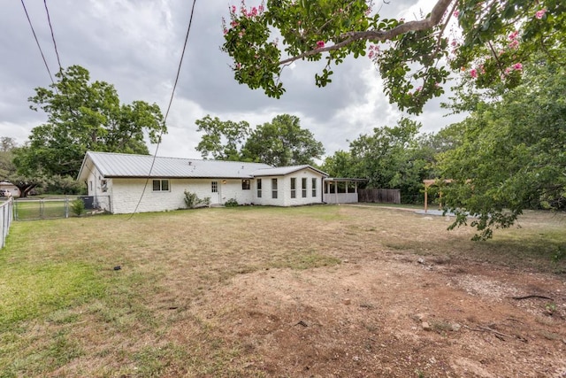 606 Lilac Dr, Round Rock, TX 78664 - back of property with a fenced backyard and a metal roof