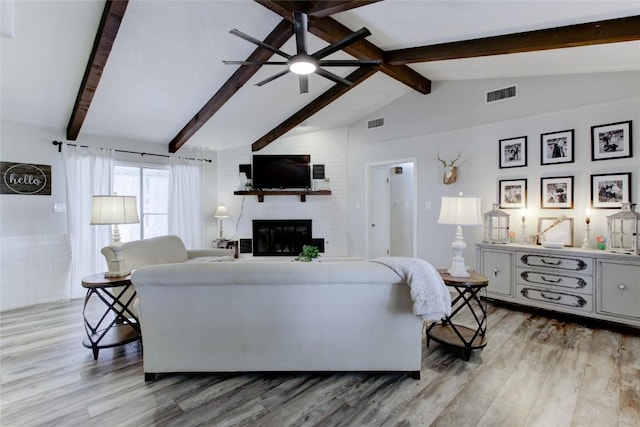 400 N Brazos St, Granger, TX 76530 - living room with light wood-style floors, a fireplace, and ceiling fan