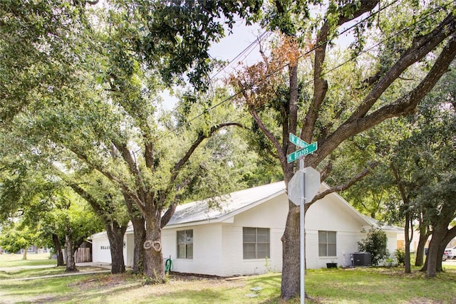 400 N Brazos St, Granger, TX 76530 - view of property exterior with an attached garage and a lawn