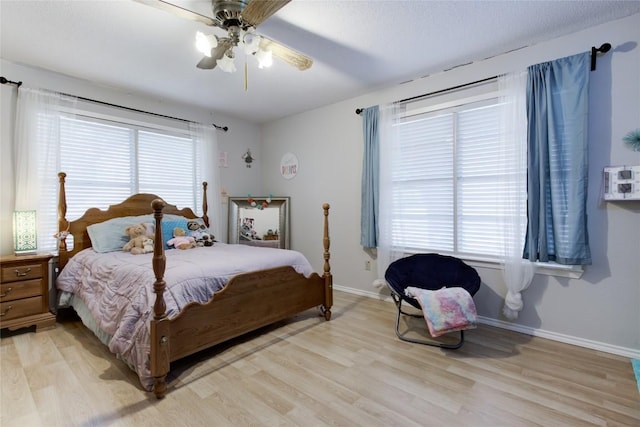 400 N Brazos St, Granger, TX 76530 - bedroom with light wood-style floors and a ceiling fan