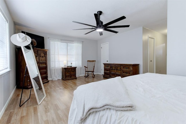 400 N Brazos St, Granger, TX 76530 - bedroom featuring wood finished floors, multiple windows, and a ceiling fan