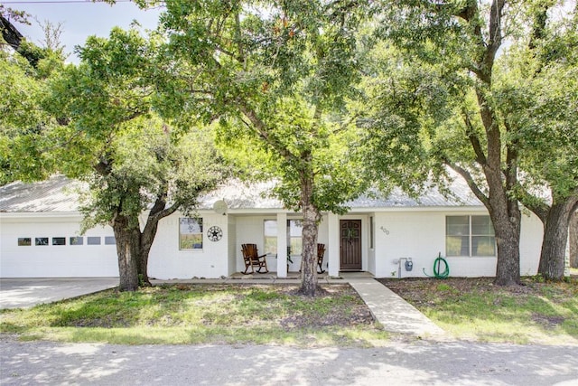 400 N Brazos St, Granger, TX 76530 - view of front of property featuring a garage, driveway, and a porch