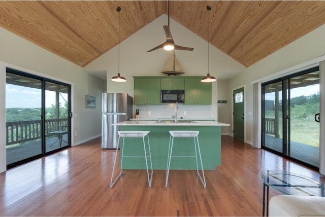 25633 Pedernales Point Dr, Spicewood, TX 78669 - kitchen featuring black microwave, green cabinets, freestanding refrigerator, wood ceiling, and light countertops