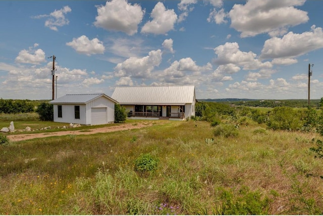 25633 Pedernales Point Dr, Spicewood, TX 78669 - view of front of property with a metal roof, a garage, and an outbuilding