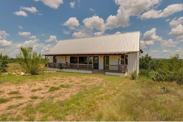 25633 Pedernales Point Dr, Spicewood, TX 78669 - view of front facade with a metal roof and covered porch