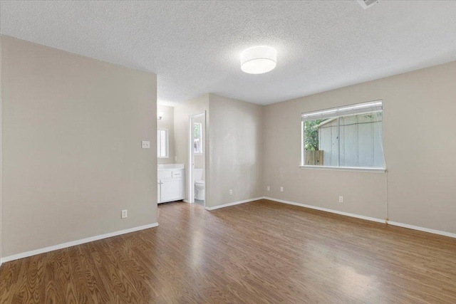 901 Pack Saddle Pass, Round Rock, TX 78681 - spare room with wood finished floors and a textured ceiling