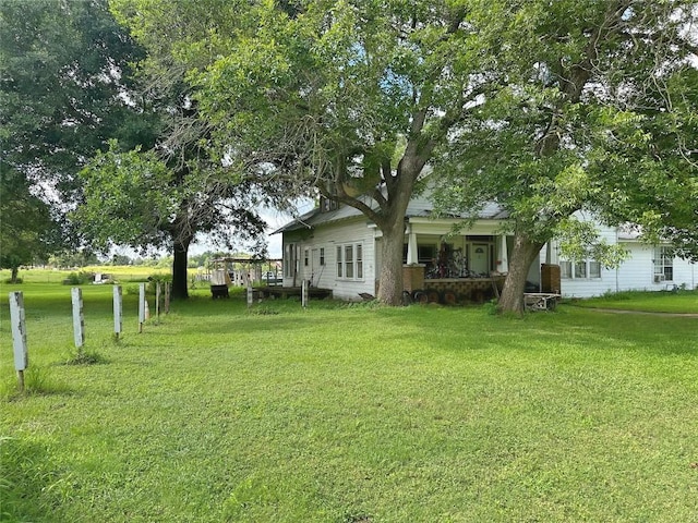 321 Douglas St, Lexington, TX 78947 - view of grassy yard featuring a porch