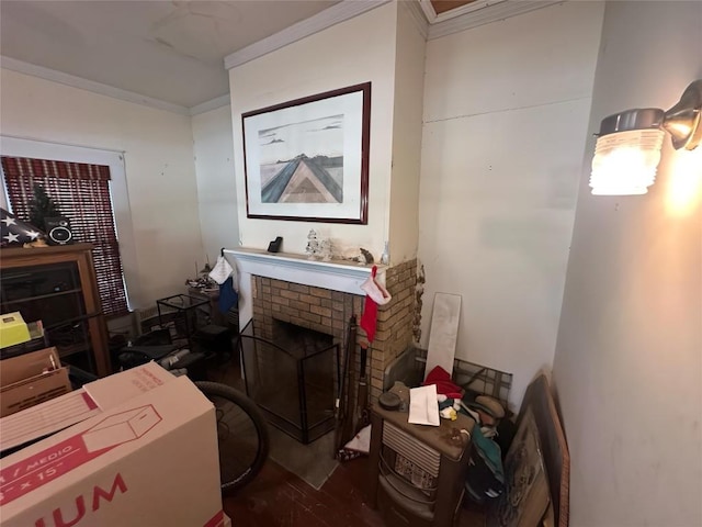 321 Douglas St, Lexington, TX 78947 - living room with crown molding, wood finished floors, and a brick fireplace
