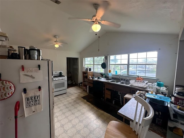 321 Douglas St, Lexington, TX 78947 - kitchen with white appliances, ceiling fan, lofted ceiling, and light floors