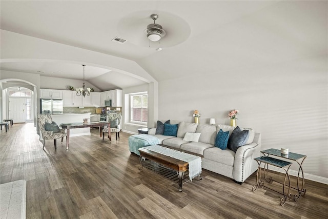 3792 Turetella Dr, Round Rock, TX 78681 - living area featuring arched walkways, vaulted ceiling, ceiling fan, wood finished floors, and a chandelier