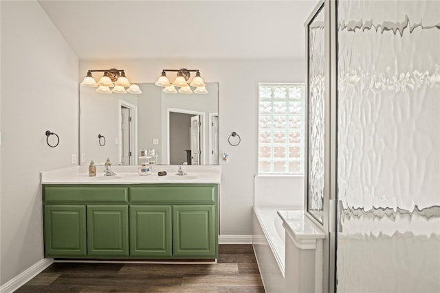 3792 Turetella Dr, Round Rock, TX 78681 - full bath with a bath, double vanity, wood finished floors, and a chandelier
