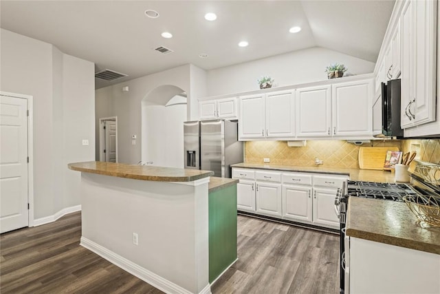 3792 Turetella Dr, Round Rock, TX 78681 - kitchen with appliances with stainless steel finishes, a center island, dark wood-style floors, arched walkways, and white cabinets